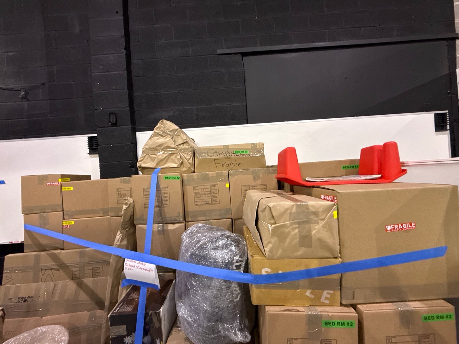 Restoration Doctor crew packing out household contents during a water damage mitigation project in Washington, DC — a real on-site pack-out photograph.